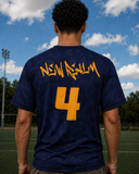 Person wearing a navy blue t-shirt with 'New Realm' and number '4' in yellow on a sports field.